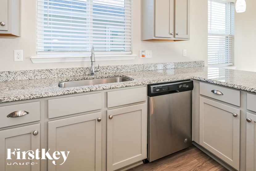 A kitchen with a sink and a dishwasher.
