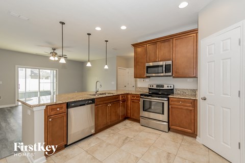 a kitchen with wooden cabinets and stainless steel appliances