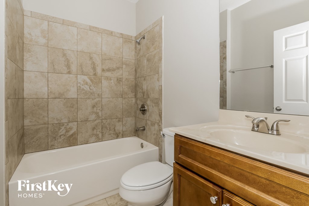 a bathroom with a sink toilet and a tub