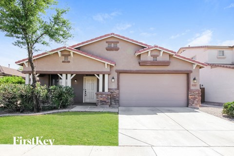 a house with a garage door and a lawn