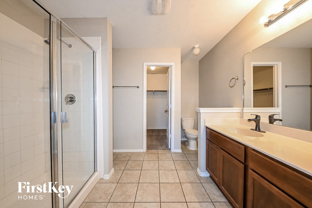 a bathroom with a shower and a sink and a mirror