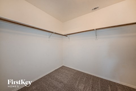 the living room of a garage with white walls and a carpet