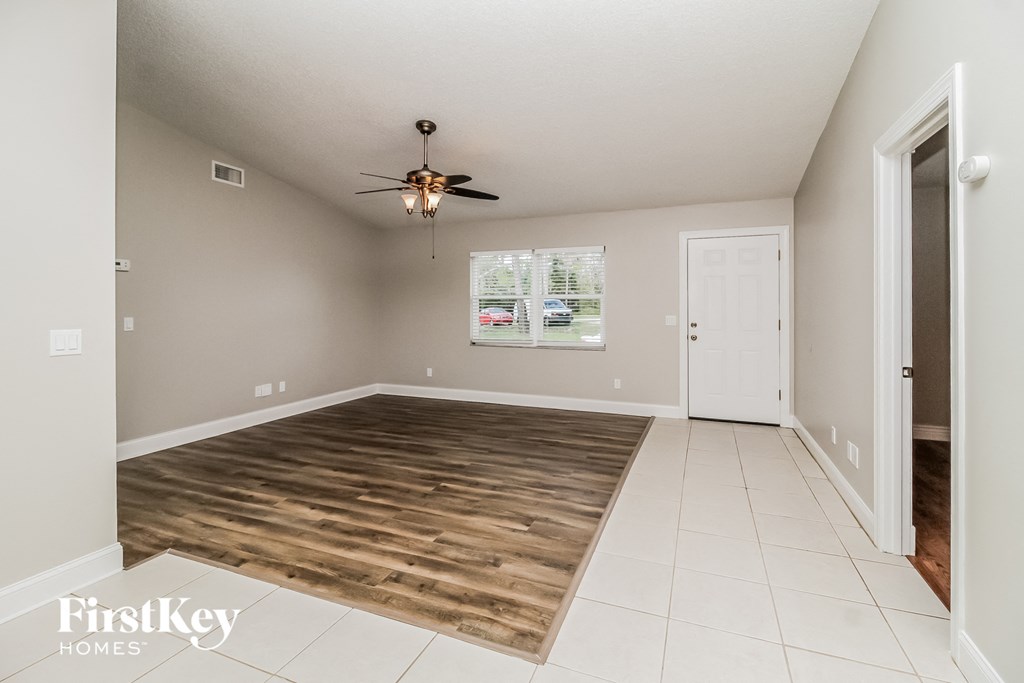 A room with a wooden floor and a ceiling fan.