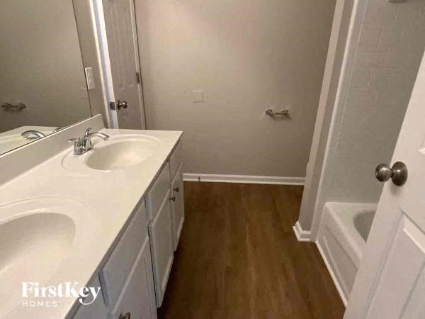 a bathroom with a white sink and a bath tub