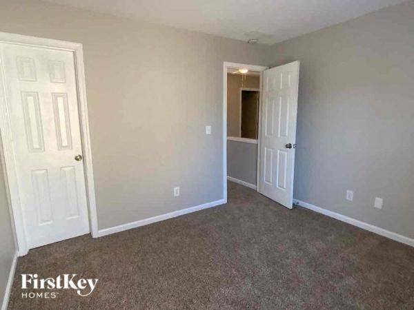 an empty room with a door and a closet
