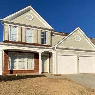 a large white house with a garage door