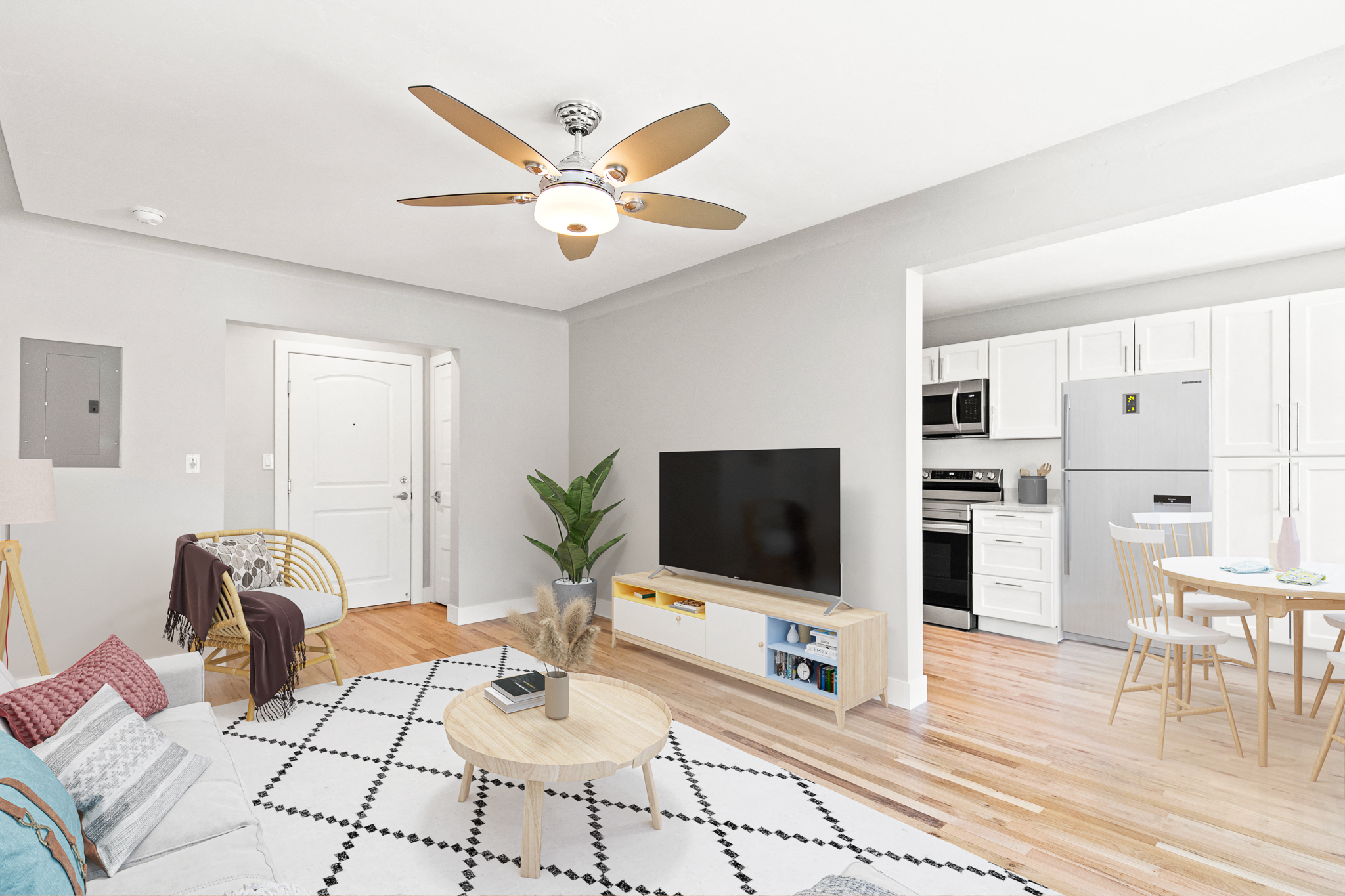 a living room with a couch and a ceiling fan