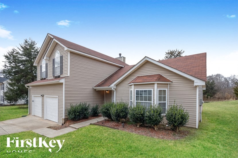 a home with a lawn and a driveway