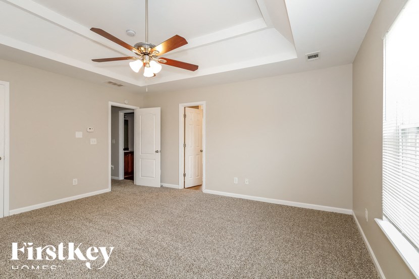 the master bedroom is spacious and has a ceiling fan