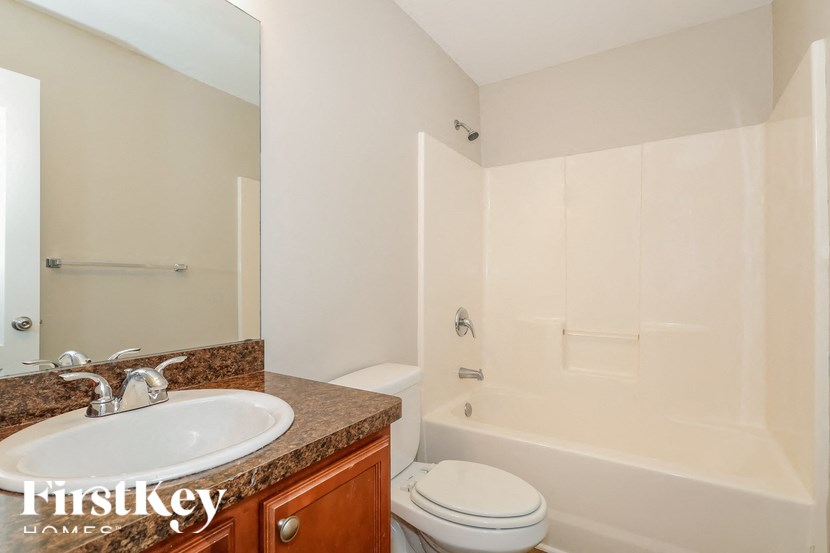 a bathroom with a sink and a toilet and a shower