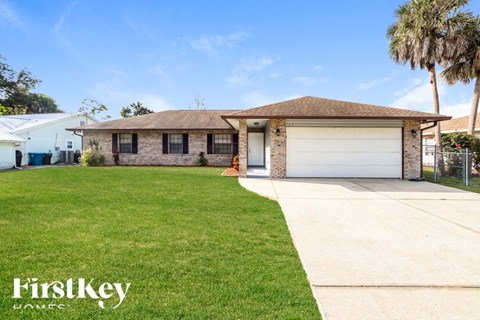 A house with a brown roof and a garage door is for sale.