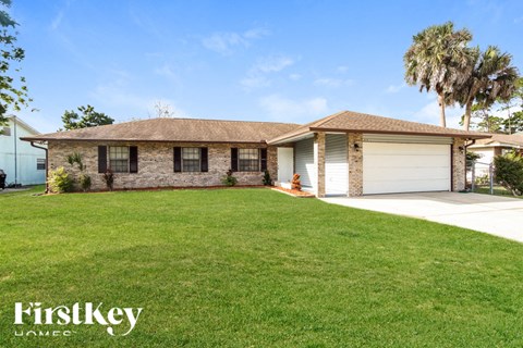A house with a brown roof and a white garage door.