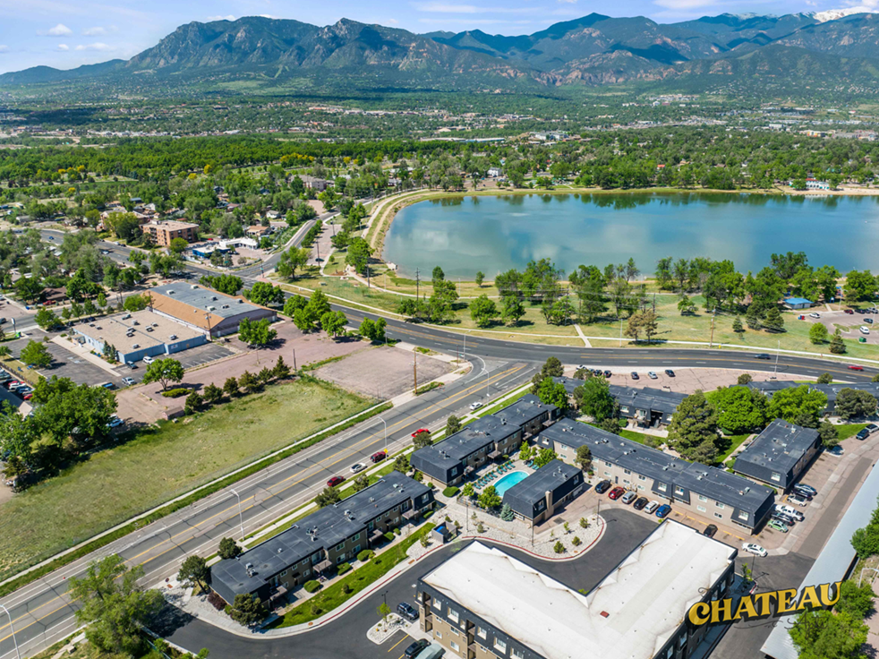 a view of a city from above with a lake and mountains