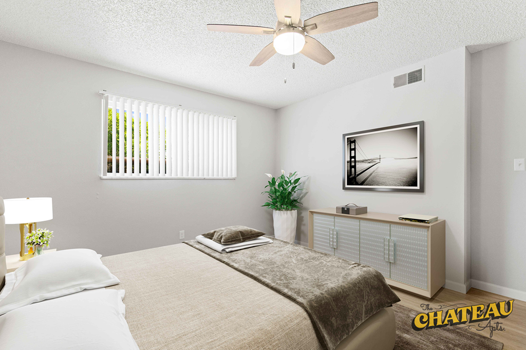 a bedroom with a bed and a ceiling fan