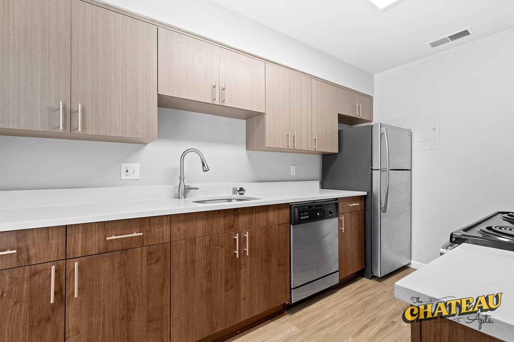 a kitchen with wooden cabinets and stainless steel appliances