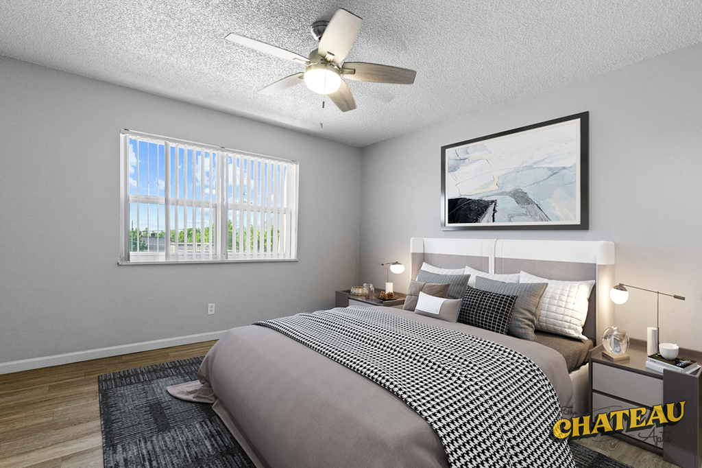 a bedroom with a bed and a ceiling fan