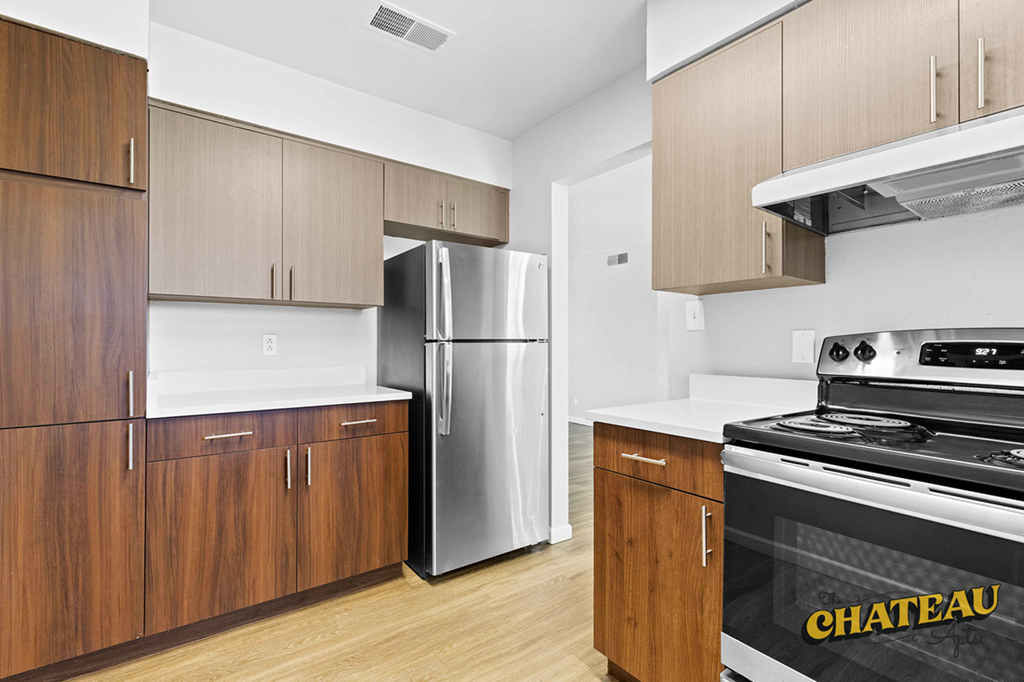 a kitchen with wooden cabinets and stainless steel appliances
