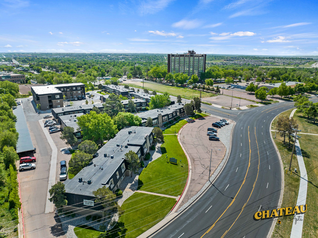 an aerial view of a city with a highway and buildings