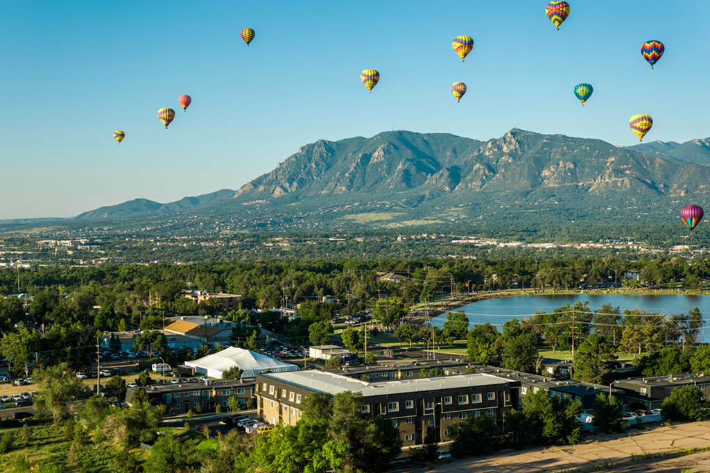 balloons over the city and mountains
