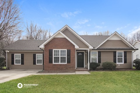 the front view of a home with a lawn and a driveway