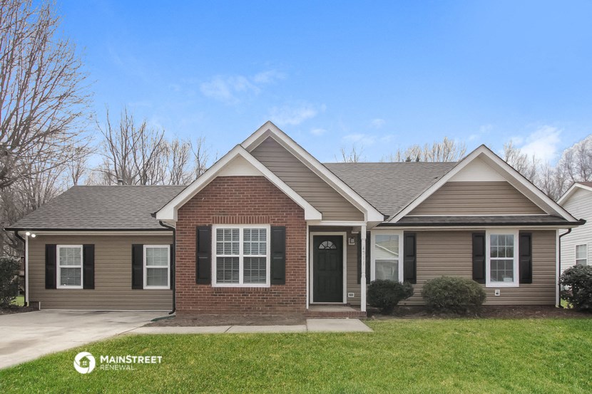 the front view of a home with a lawn and a driveway