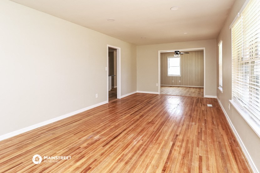 the living room and dining room with wood flooring