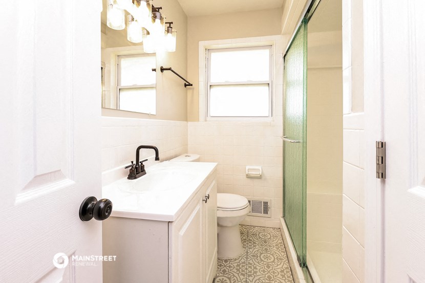 a bathroom with a toilet and a sink and a shower