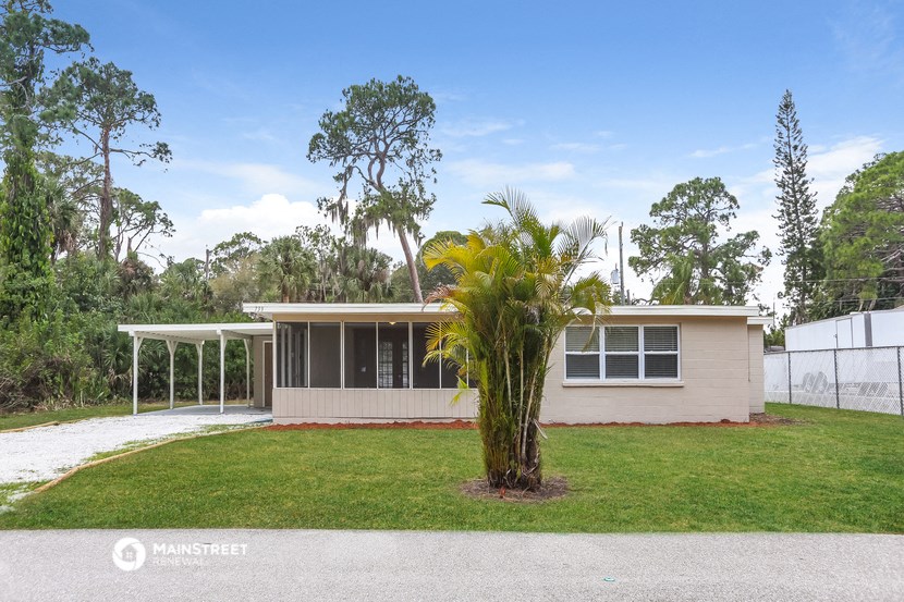 a house with a palm tree in front of it