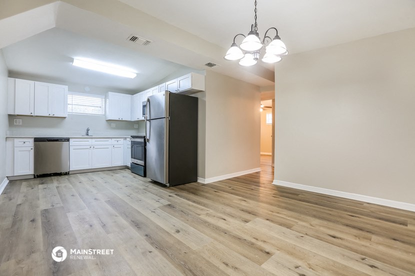 the kitchen is open to the living room and dining room