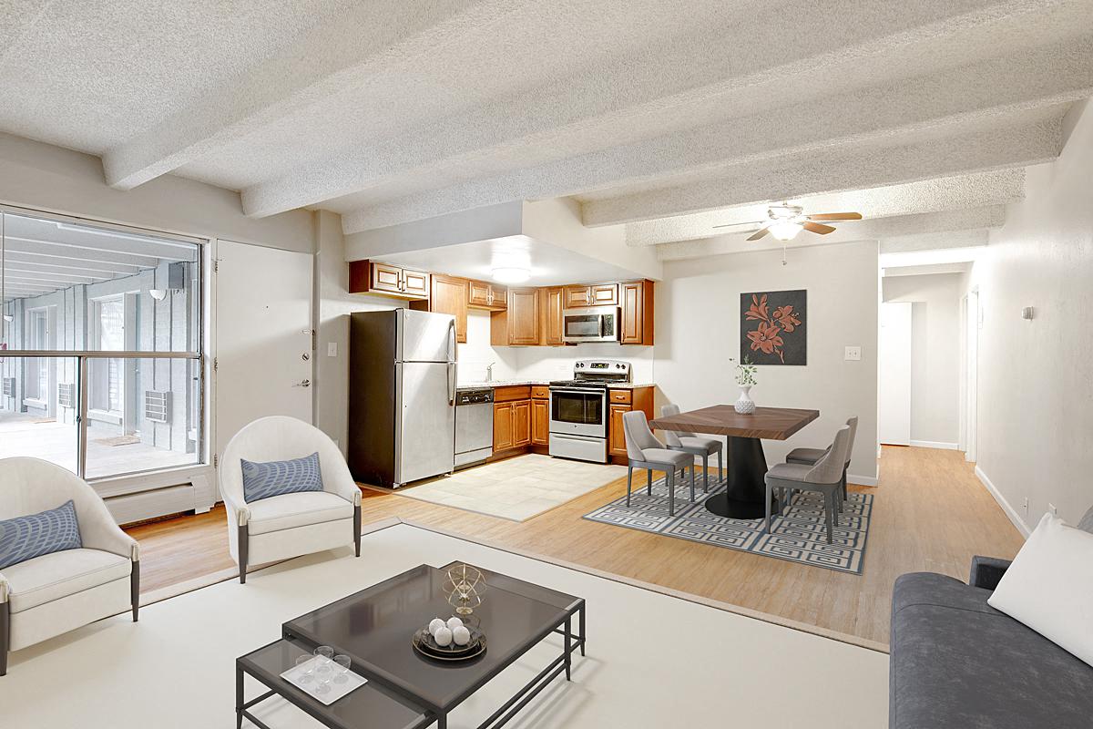 a living room and kitchen with a table and chairs