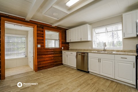 a kitchen with white cabinets and a counter top