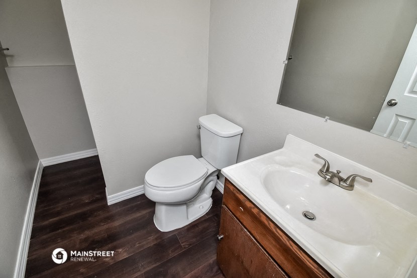 a bathroom with a toilet and a sink and a mirror