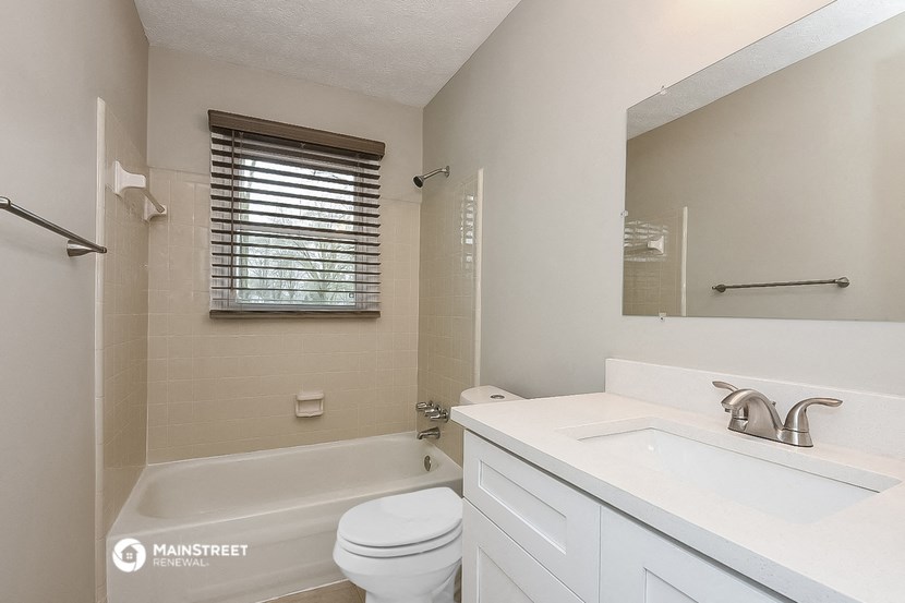 a bathroom with a sink toilet and a bath tub