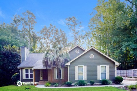 a blue house with a palm tree in front of it