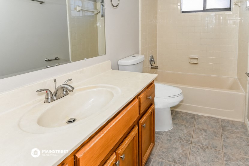 a bathroom with a sink and a tub and a toilet
