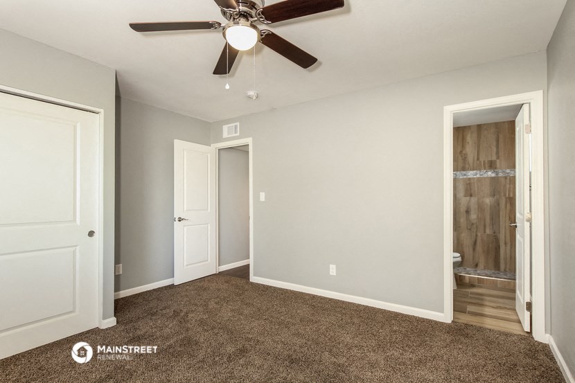 the master bedroom is spacious and has a ceiling fan
