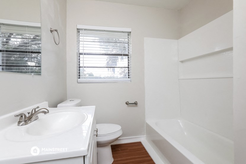 a bathroom with a sink toilet and a bath tub