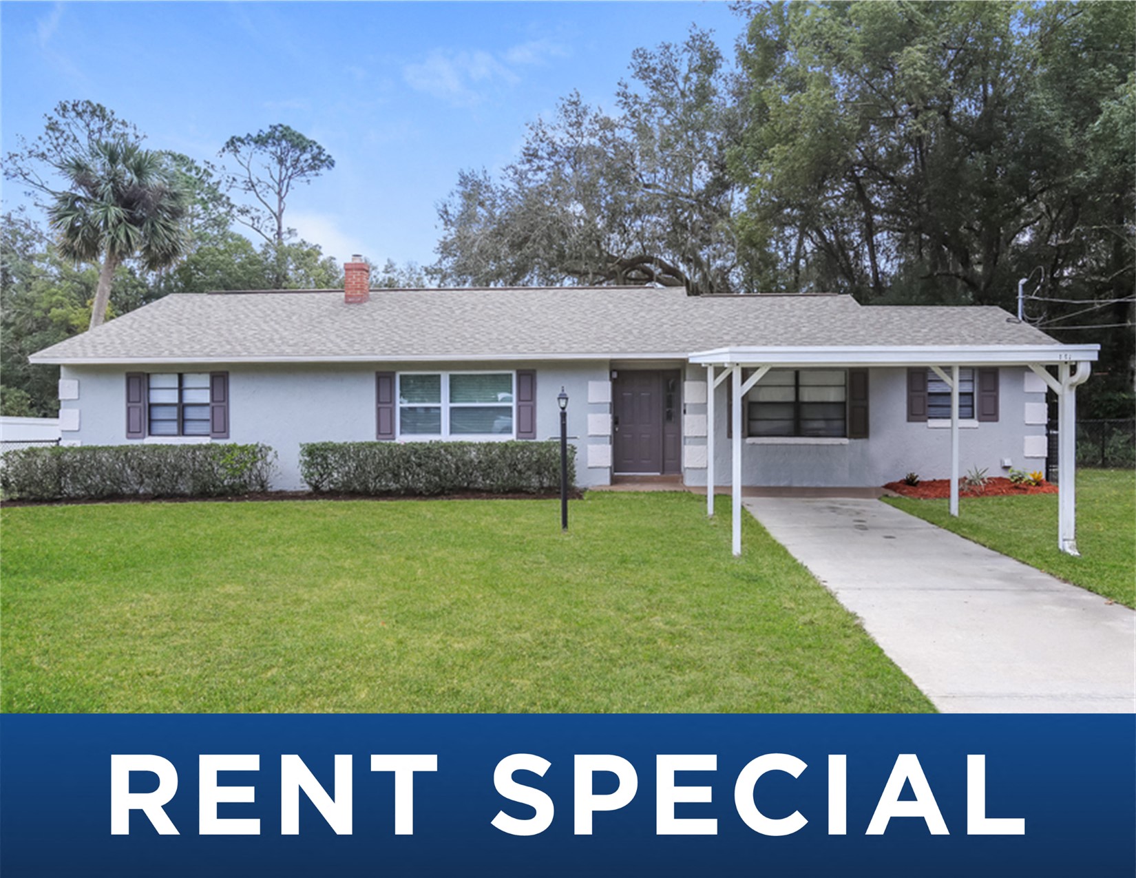 a small white house with a lawn and a driveway