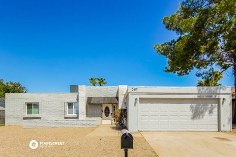 a white house with a driveway and a white garage door