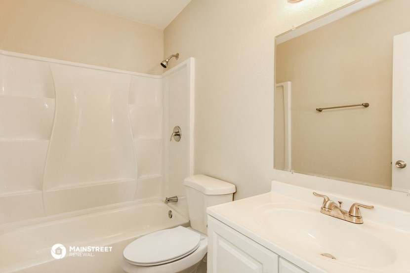 a bathroom with a sink toilet and a bath tub