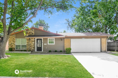 a house with a lawn and a garage door