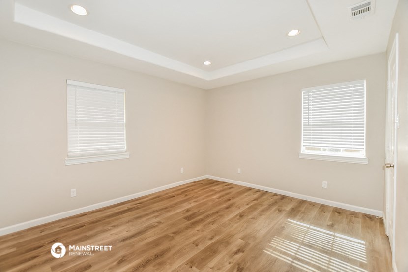 the living room of a new home with wood floors and white walls