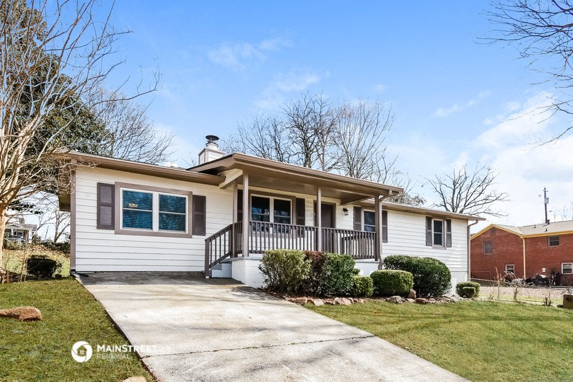 a white house with a sidewalk in front of it