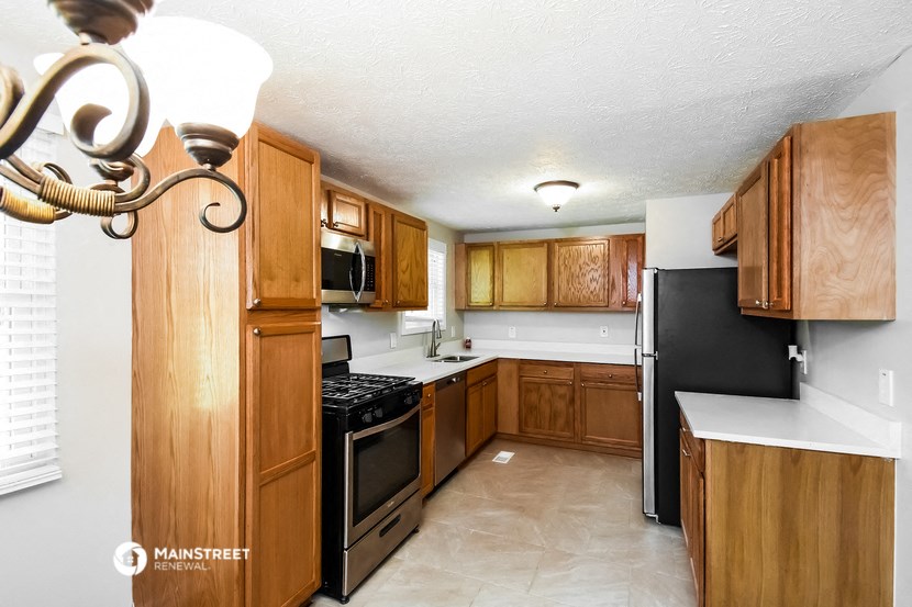 a kitchen with wooden cabinets and black appliances