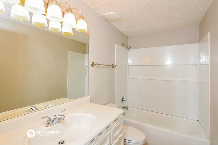 a bathroom with a sink and a shower and a toilet