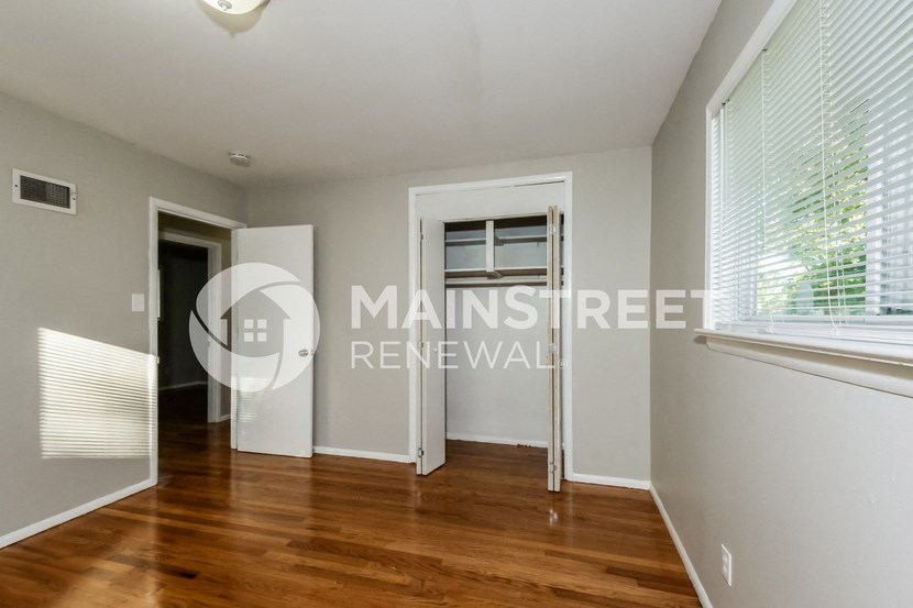 a bedroom apartment with a hardwood floor and a window