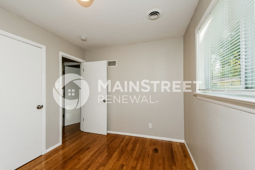 a bedroom apartment with a closet and a window