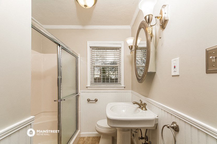 a small bathroom with a sink toilet and shower