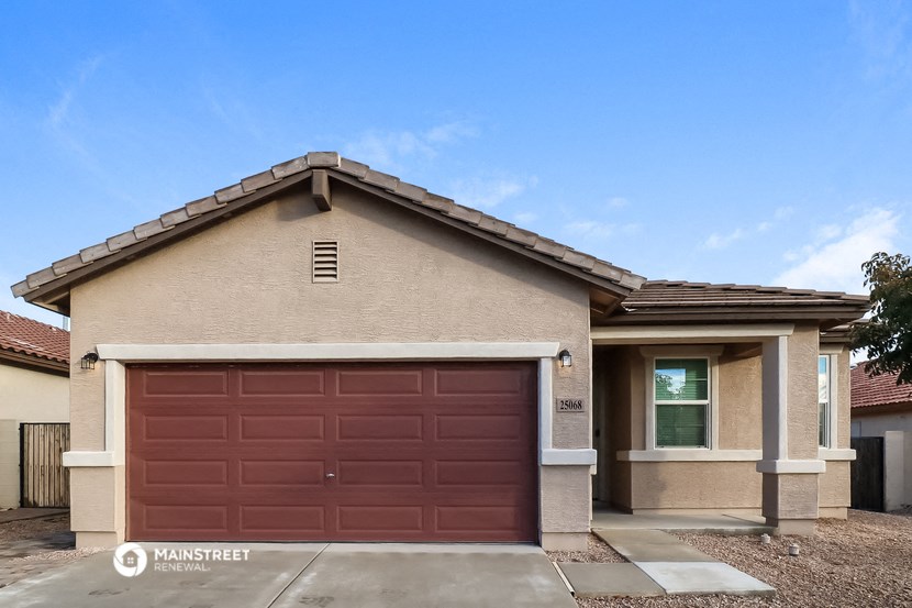 a home with a brown garage door in front of it