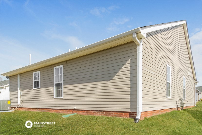 the exterior of a house with vinyl siding and a roof